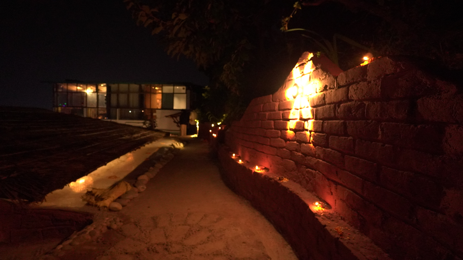 Pathway lit with diyas at night