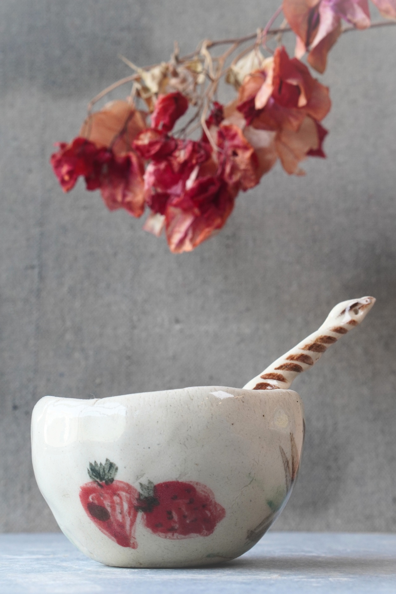 Handmade ceramic cacao cup with strawberry motif from Aavya Pottery Studio, Rishikesh