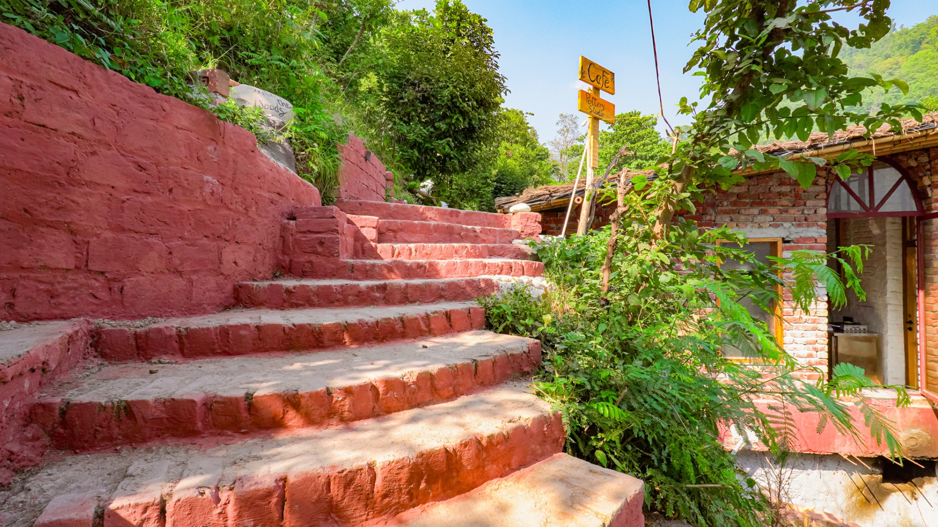 Red brick steps with garden at Aavya